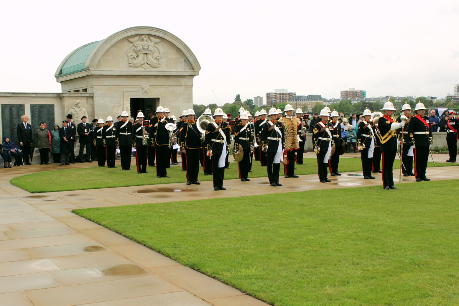 The band standing to one side of the memorial event.